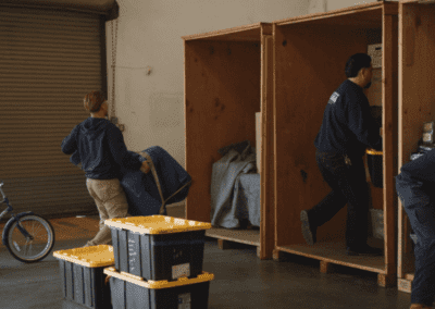 Expert Movers are loading household goods into secure wooden storage vaults